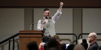 Richard Spencer gives white power salute during a talk at Texas A&M University, Dec 2016 (source: AP via ABC news, https://abcnews.go.com/US/hundreds-protest-white-nationalist-texas-university/story?id=44029112)