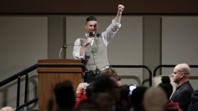 Richard Spencer gives white power salute during a talk at Texas A&M University, Dec 2016 (source: AP via ABC news, https://abcnews.go.com/US/hundreds-protest-white-nationalist-texas-university/story?id=44029112)