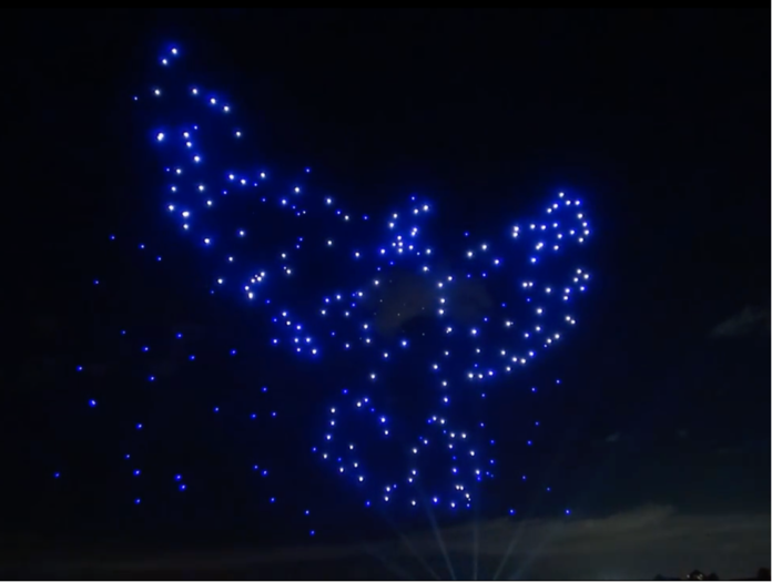 Drone swarm forming a peace dove © Disney Starbright Holidays Light Show, 2016 [still from private video recording